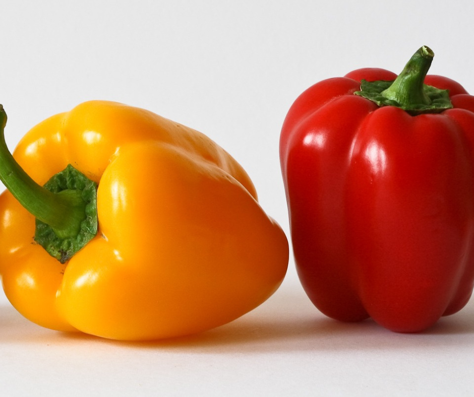 Yellow and red bell peppers on white background.