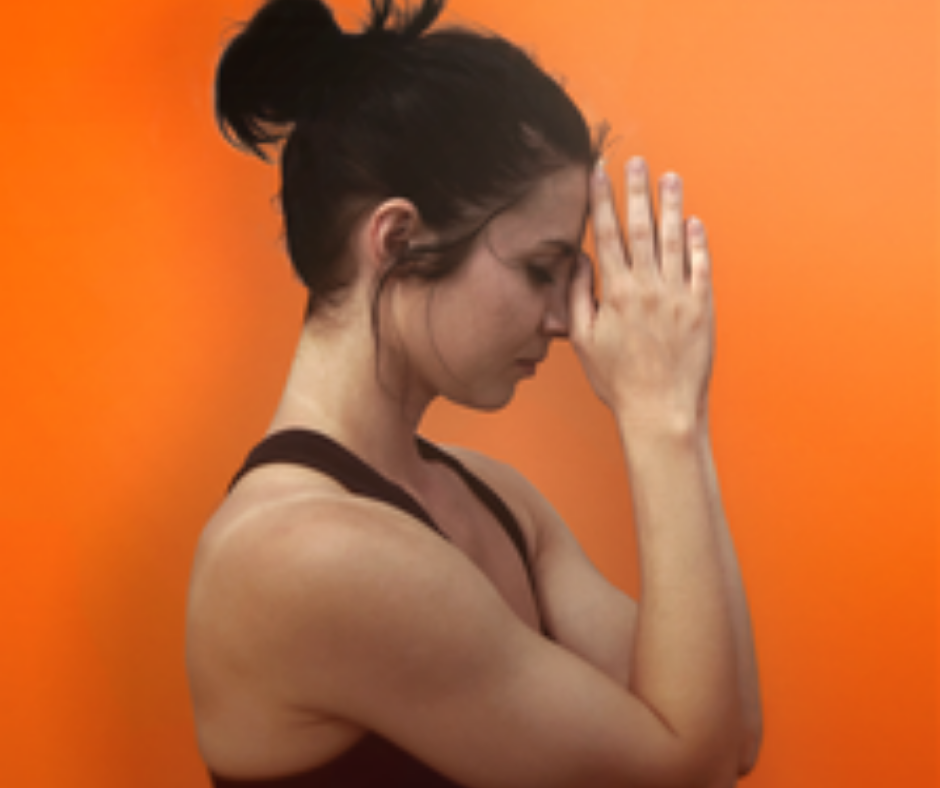 Woman in contemplation against orange background.