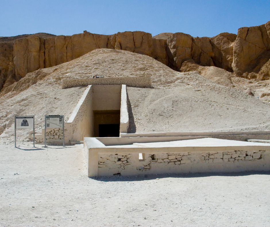 Ancient Egyptian tomb entrance in desert landscape.
