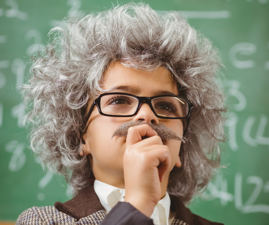 Child dressed as scientist with wig and glasses.