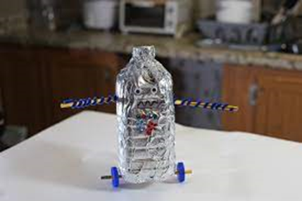 Handmade bottle rocket model on kitchen counter.