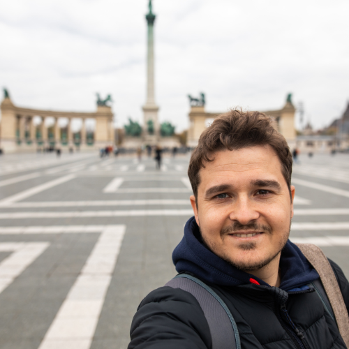 Man taking selfie at Heroes' Square in Budapest.