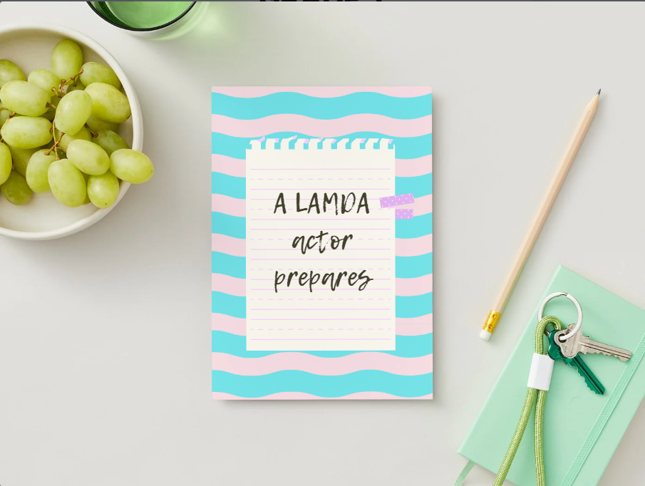 Pastel notebook with handwritten acting note on desk